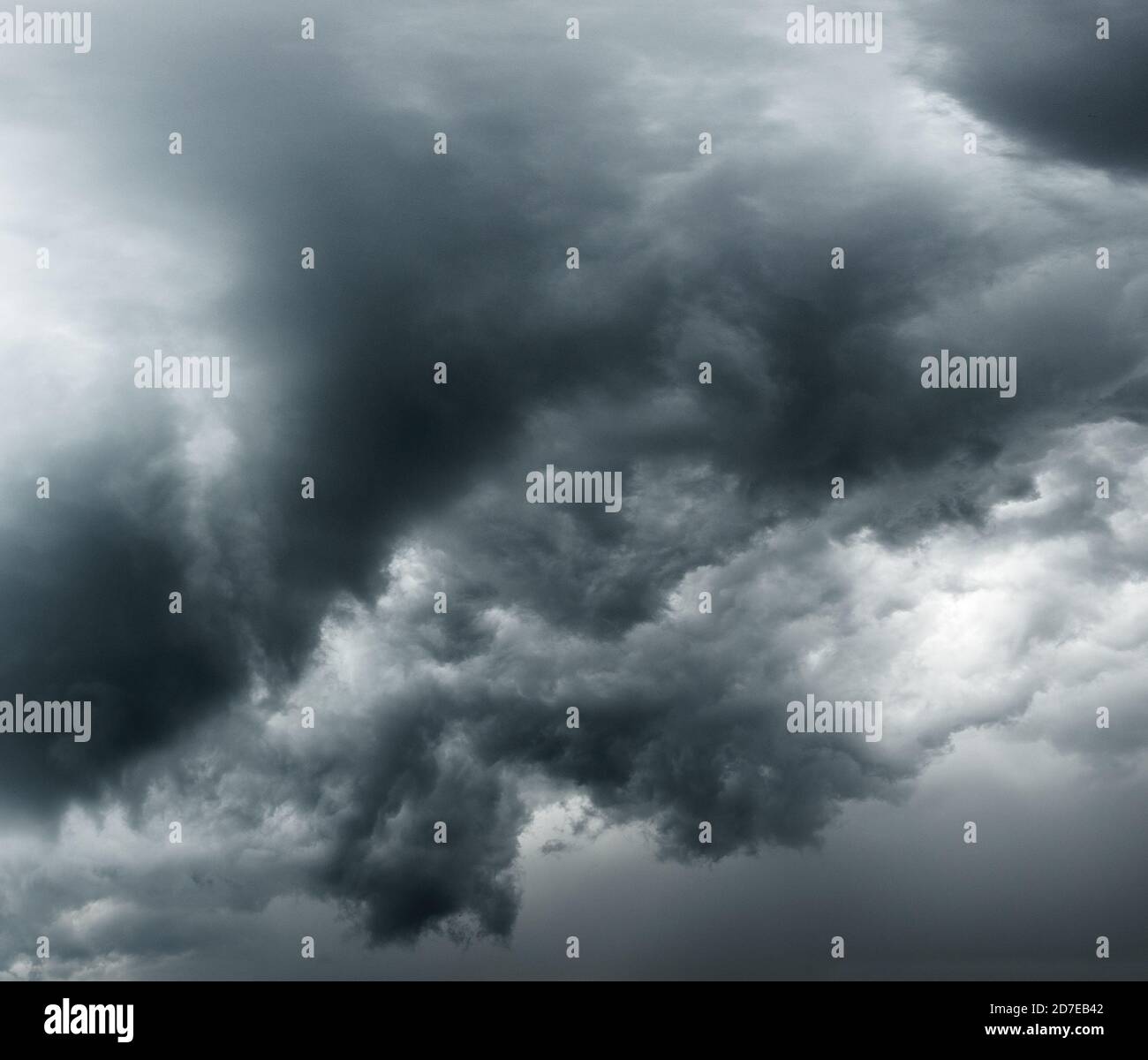 Black and white background of dark stormy clouds in gray moody sky ...