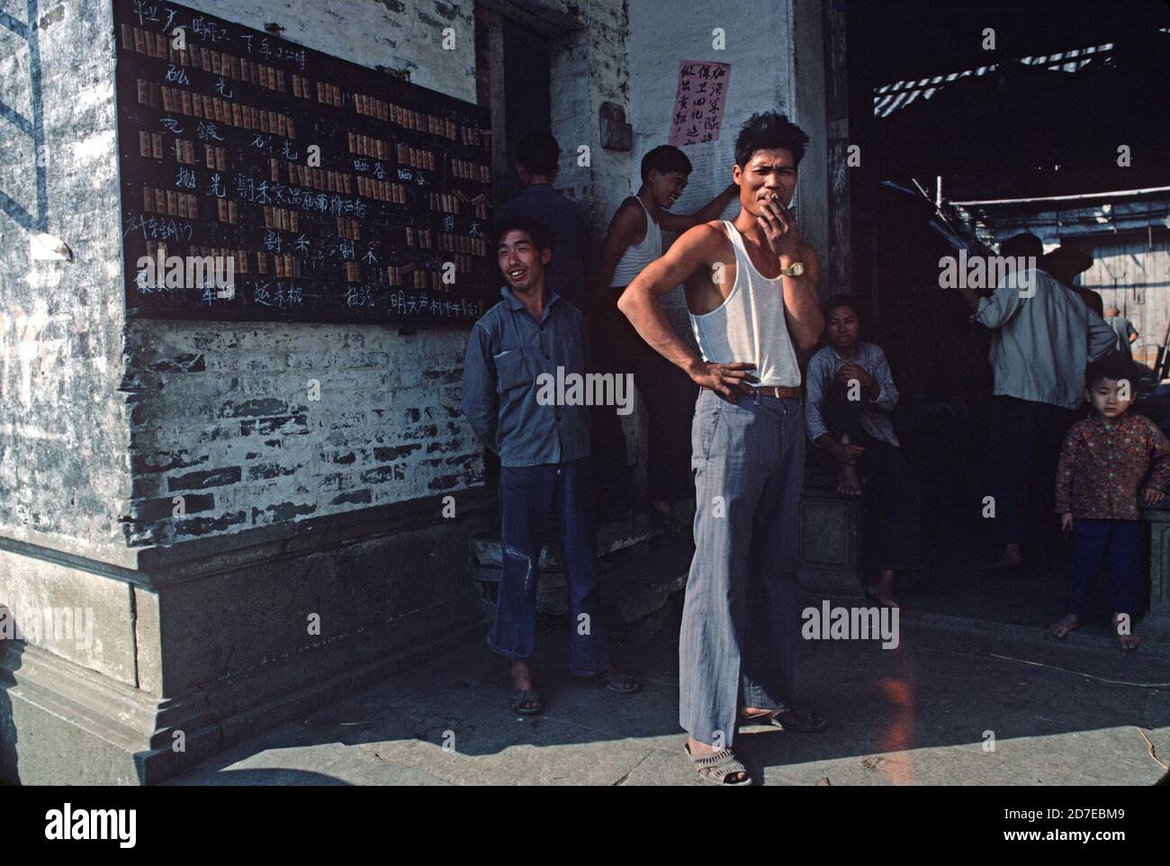 Worker smoking outside factory, Shanghai. China, 1980s Stock Photo
