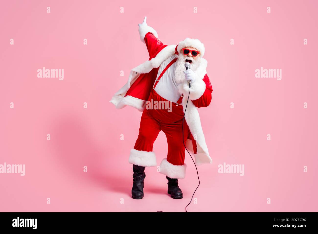 Full length photo crazy north-pole celebrity grey beard santa claus big  belly sing song mic christmas x-mas eve wear suspenders sunglass stylish  cap Stock Photo - Alamy