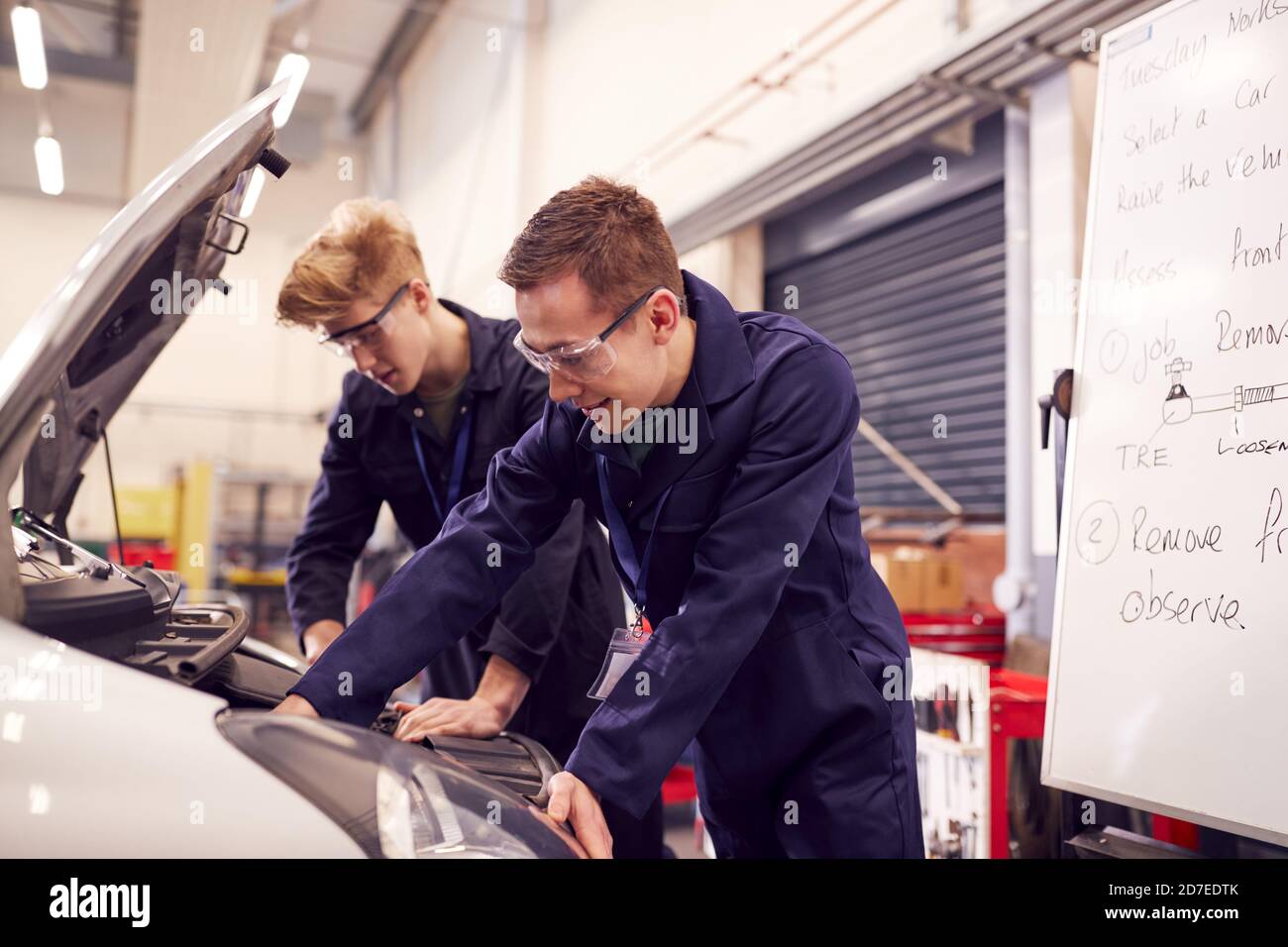 Two Male Students Studying For Auto Mechanic Apprenticeship At College ...