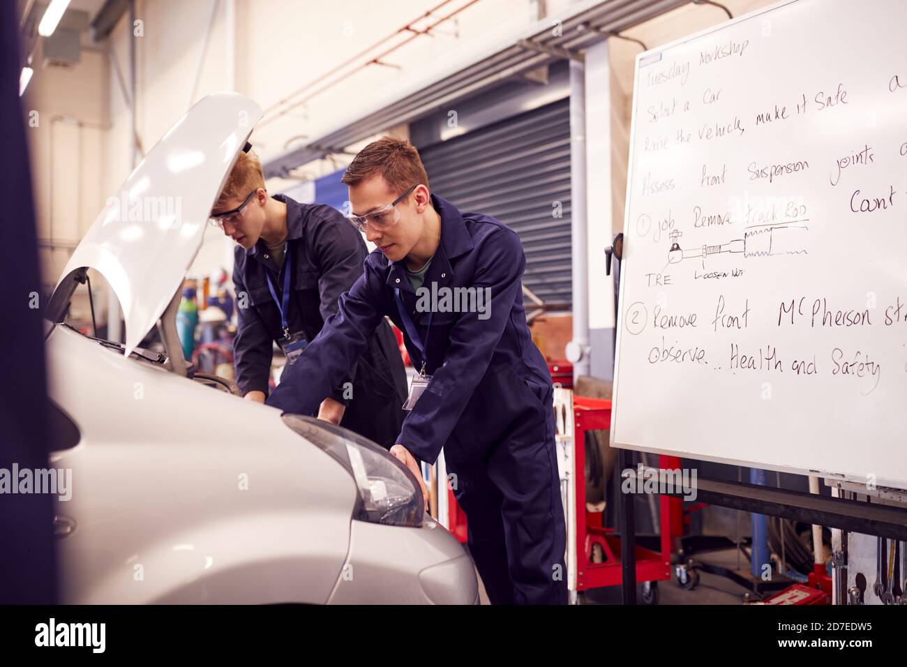Two Male Students Studying For Auto Mechanic Apprenticeship At College ...