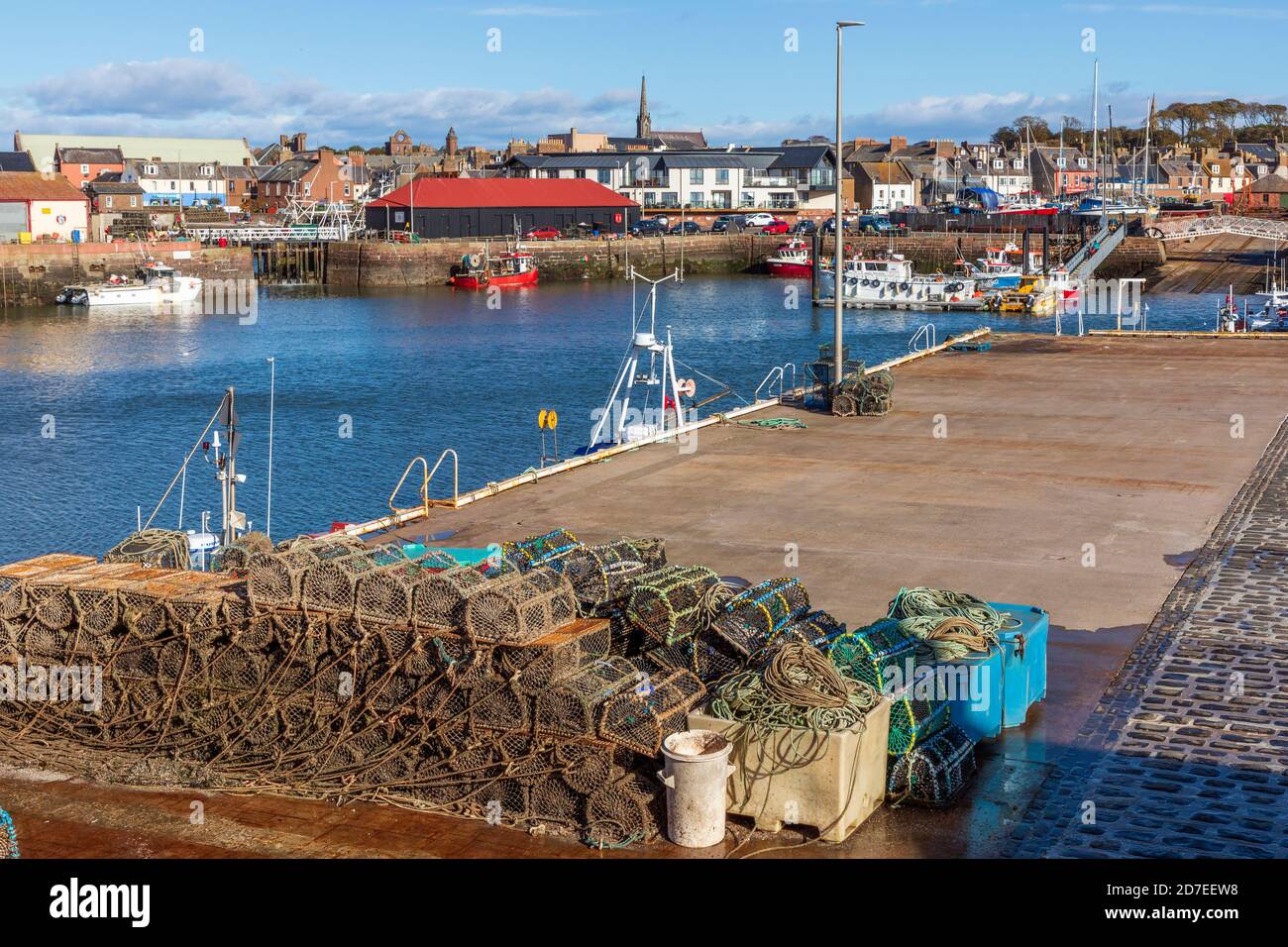 Arbroath harbour with lobster pots and a view to the fish market and town behind, Angus, Scotland, UK Stock Photo