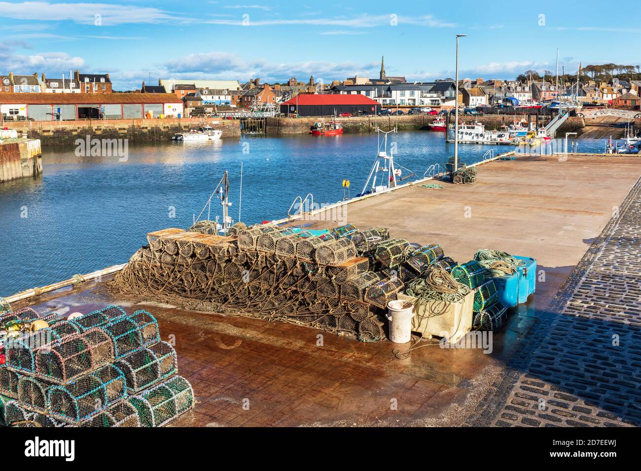Arbroath harbour with lobster pots and a view to the fish market and town behind, Angus, Scotland, UK Stock Photo