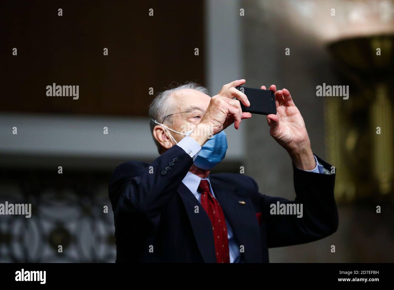 Washington, Dc, USA. 21st Oct, 2020. U.S. Senator Charles Grassley (R-IA) takes a photo with his mobile phone while attending a Senate Judiciary Committee meeting on the nomination of Judge Amy Coney Barrett to be an associate justice of the U.S. Supreme Court, on Capitol Hill in Washington, U.S., October 22, 2020. (Photo by Hannah McKay/Pool/Sipa USA) Credit: Sipa USA/Alamy Live News Stock Photo