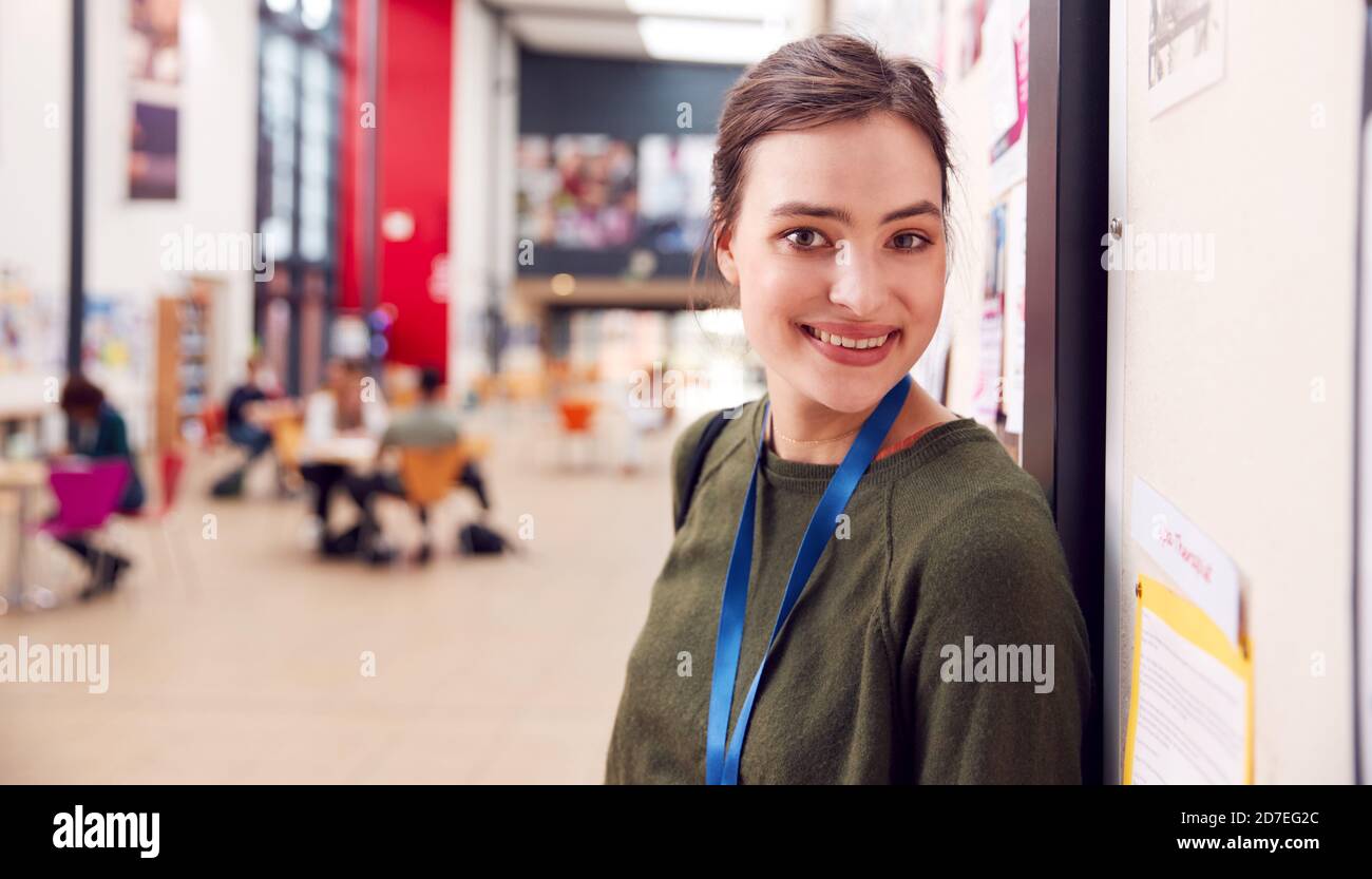 Portrait Of Smiling Female College Student In Busy Communal Campus ...