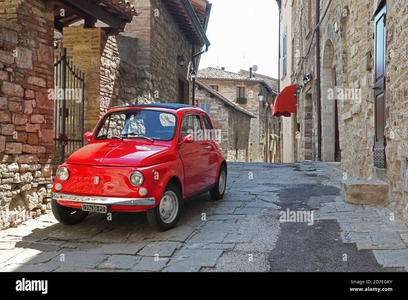 Old red Fiat 500 in narrow street of the town Stock Photo