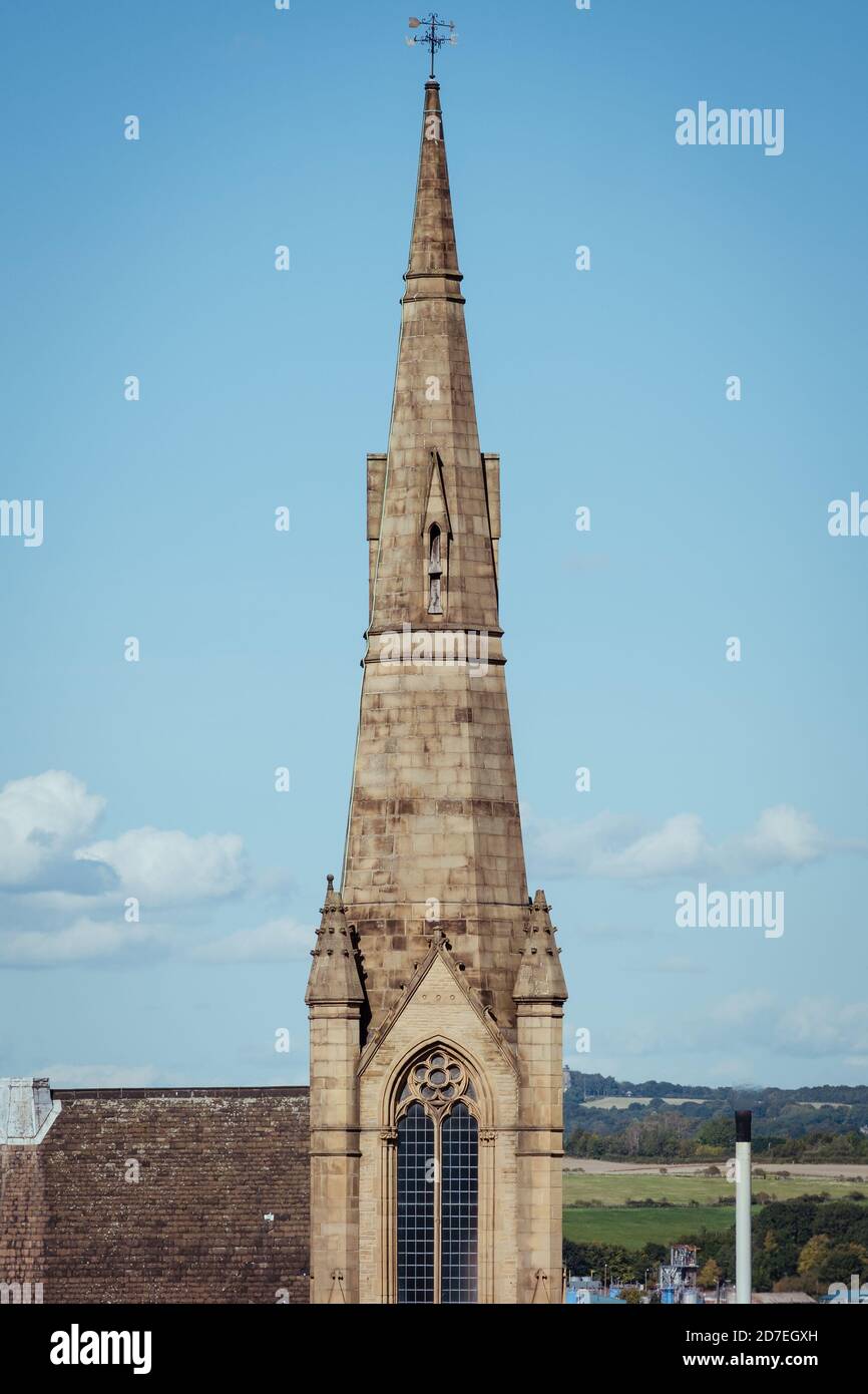The tower, spire, pointed arch window and ornate gothic architecture of the steeple of the central Rotherham methodist church Stock Photo