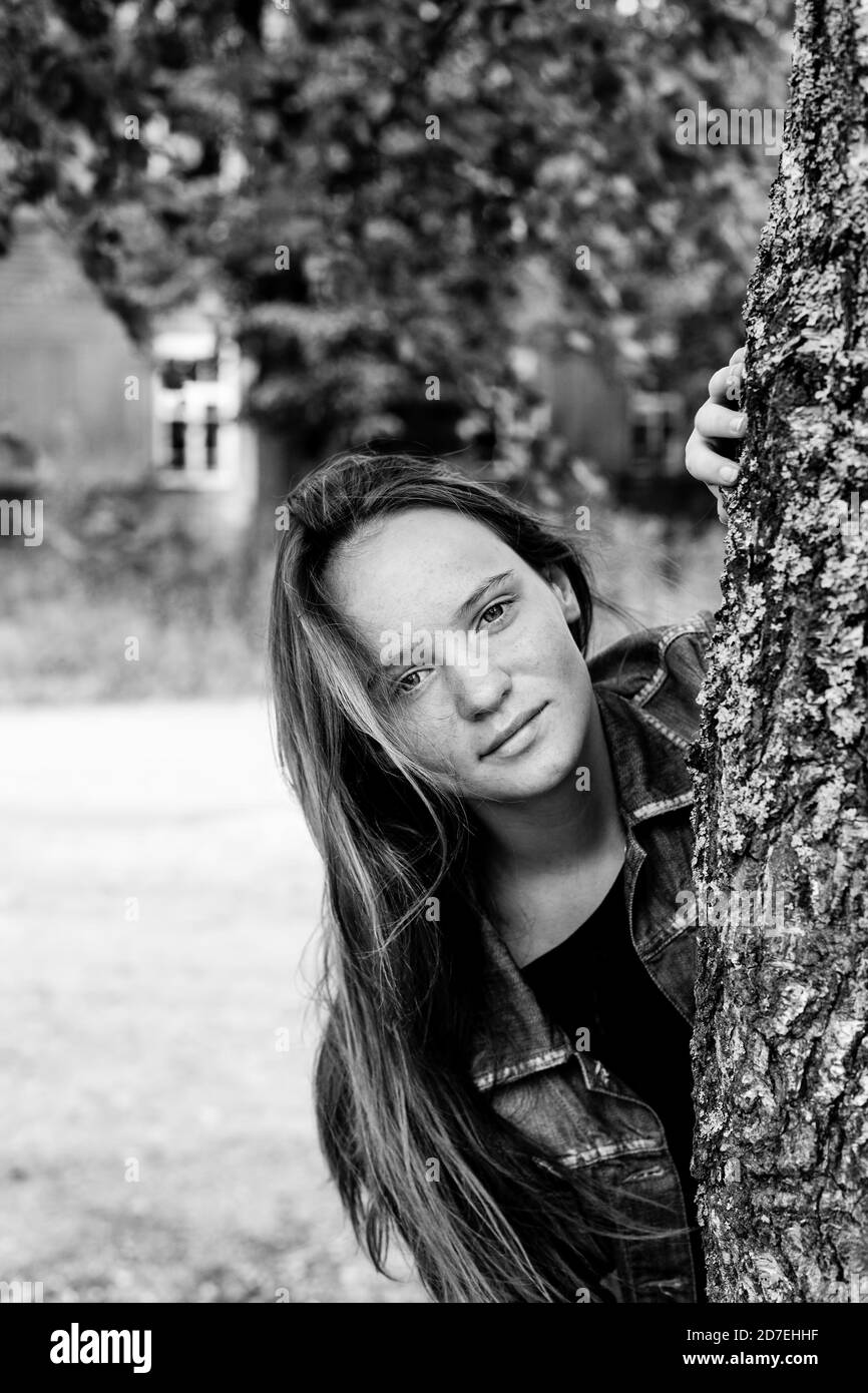 Teen girl in the birch. Black and white photography. Stock Photo