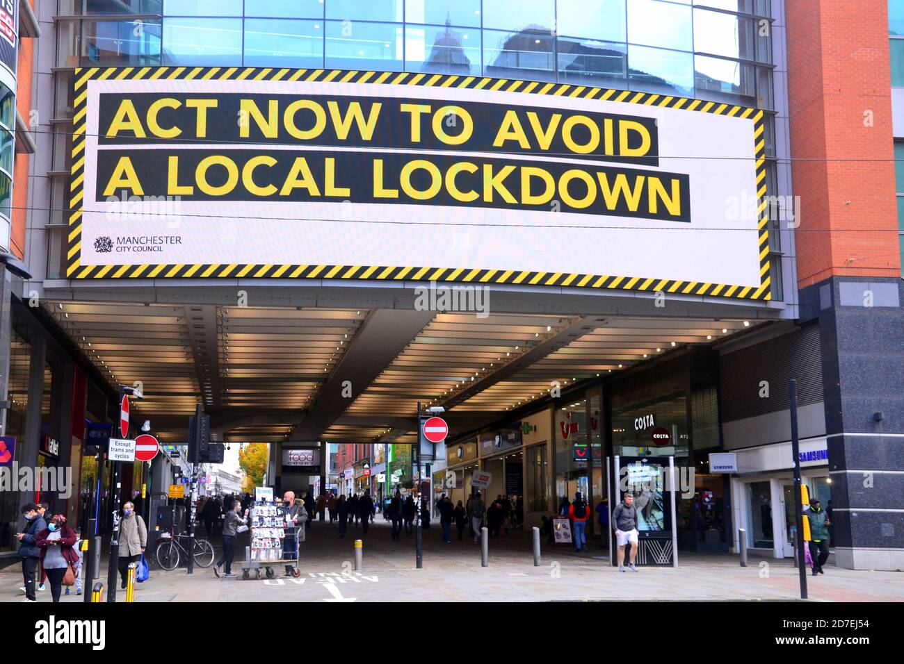 Covid 19 or coronavirus signage and advertising in Manchester, Greater Manchester, England, United Kingdom. An illuminated sign paid for by Manchester City Council on the Arndale shopping centre urges people to act now to avoid a local lockdown. Stock Photo