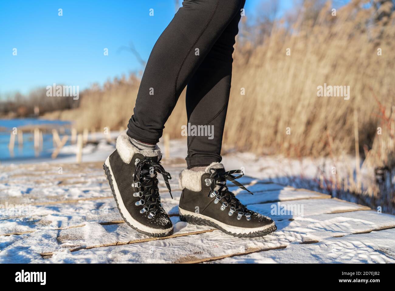 Snow boots fashion footwear for winter season girl wearing black leather ankle shoes Stock Photo