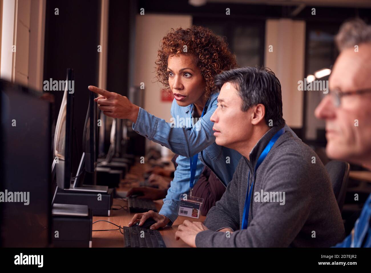 Teacher With Group Of Mature Adult Students In Class Working At ...