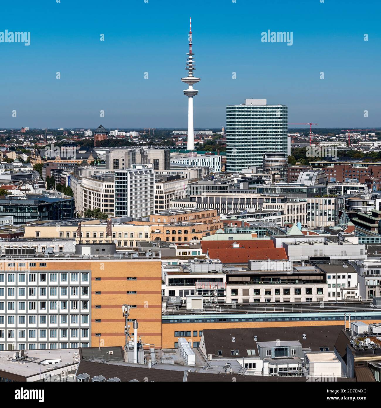 View north over the rooftops from St. Nikolai Memorial in Hamburg, to TV Tower - Fernsehturm - Heinrich Hertz Tower - in the distance. Stock Photo