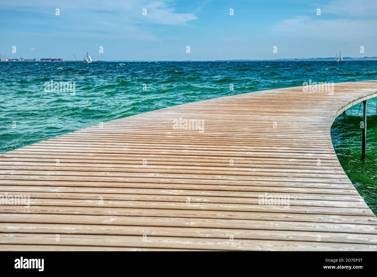 Den Uendelige Bro or Infinite Bridge is a circular jetty, pier or wooden round wharf that allows people to walk on the calm Baltic Sea in circles Stock Photo