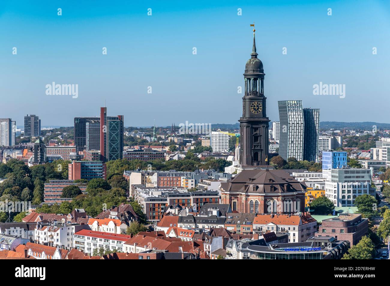 View west over the rooftops from St. Nikolai Memorial in Hamburg, to St. Michael's Church and Tanzende Türme / Tango Türme - Dancing Towers. Stock Photo