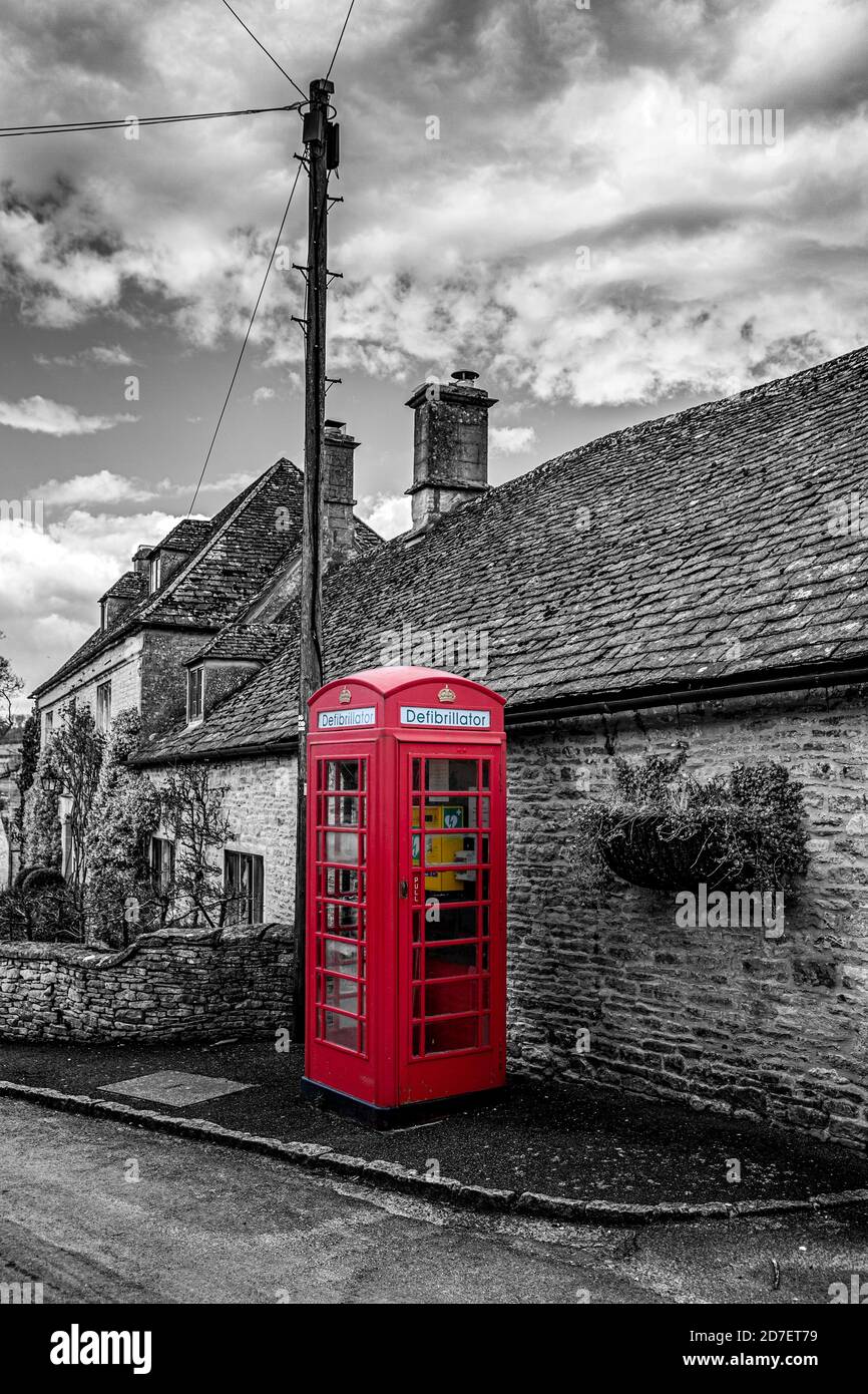 Red telephone box in a village Stock Photo