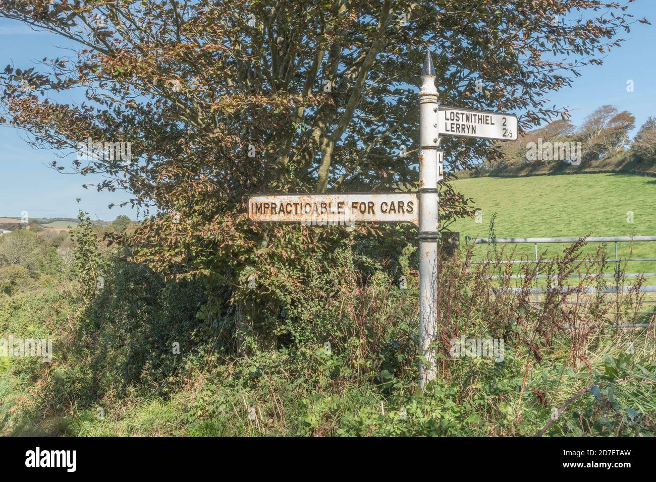 Old style rural road sign with 'Impracticable for Cars' sign near St. Winnow, Cornwall. Rural road not suitable for cars, off-roading, rough track. Stock Photo