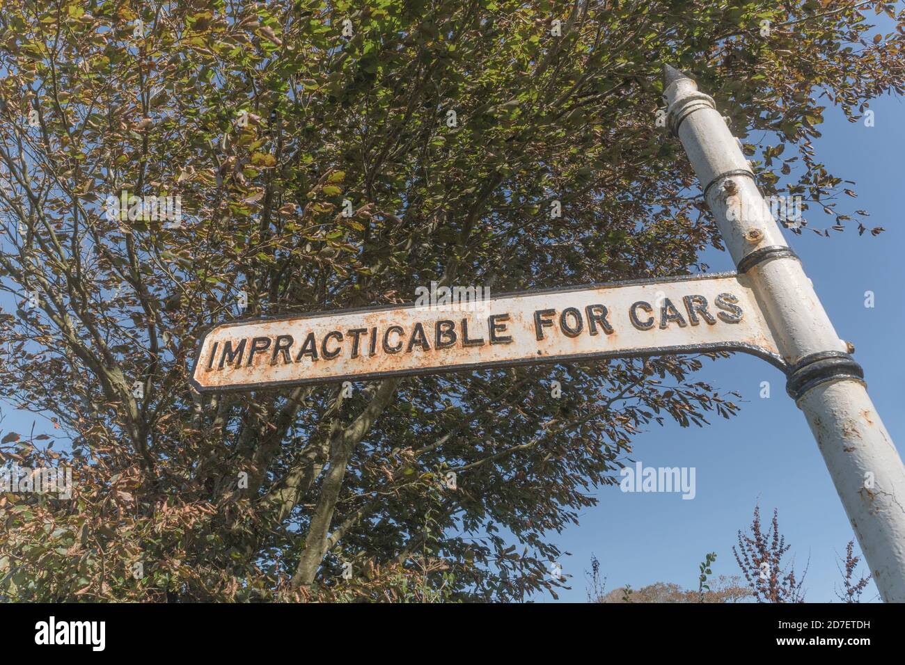 Old style rural road sign with 'Impracticable for Cars' sign near St. Winnow, Cornwall. Rural road not suitable for cars, off-roading, rough track. Stock Photo