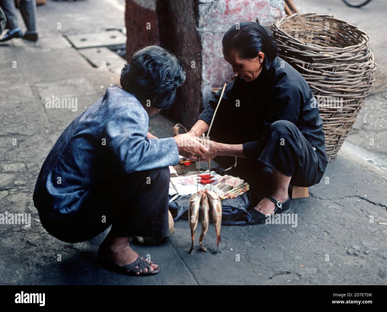Customer with recently bought fish in street market, Guangzhou, China Stock Photo