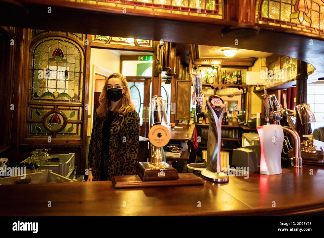 Manchester, UK. 22nd Oct, 2020. Paige starts her shift at the Peveril Of The Peak pub ahead of the city going in Tier-3 of a local lockdown. Today is the last day of trading for some local businesses as a Tier 3 lockdown has been enforced on the city and surrounding region, to try and slow down the spread of COVID-19. Credit: Andy Barton/Alamy Live News Stock Photo