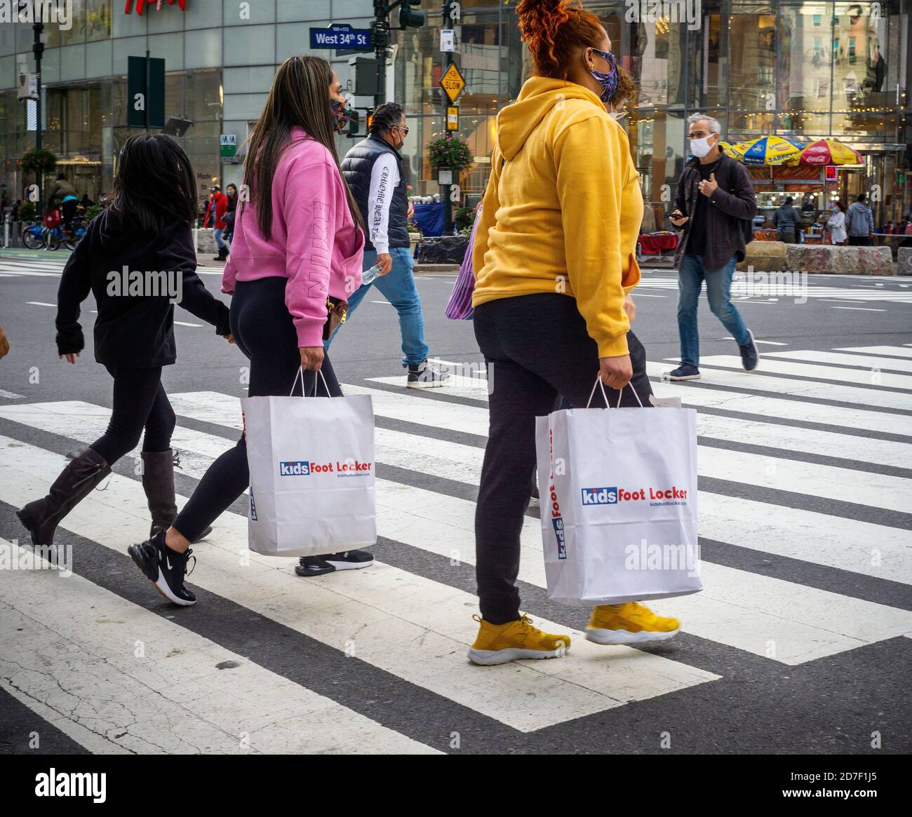 Shoppers with their Foot Locker purchases in Herald Square New York on ...