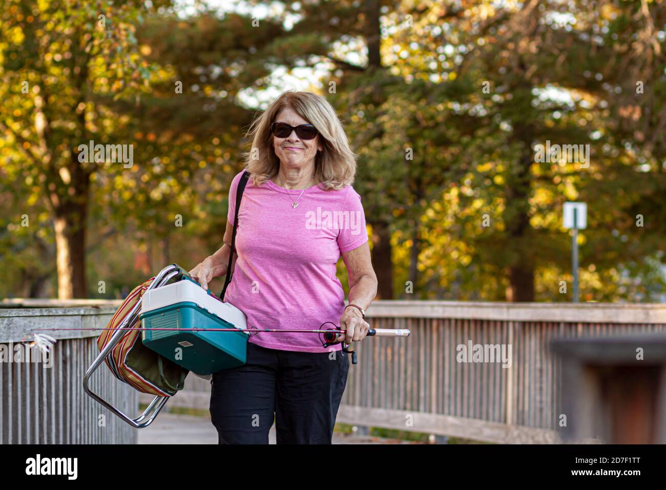 Frederick, MD, USA 10/14/2020: A middle aged caucasian woman with blonde  hair is going fishing alone in Baker Park. She has a fishing rod, a tackle  bo Stock Photo - Alamy
