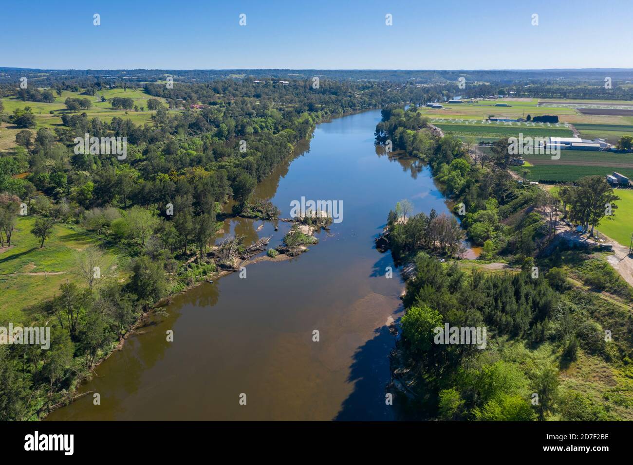 Aerial view of the Hawkesbury River running through agricultural farmland in regional New South