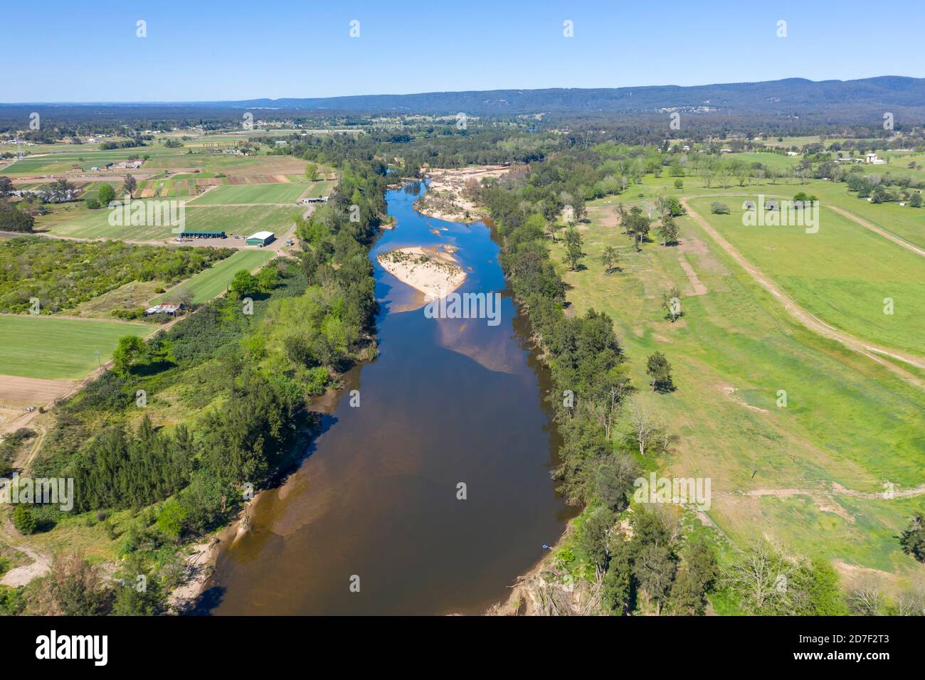Aerial view of the Hawkesbury River running through agricultural farmland in regional New South