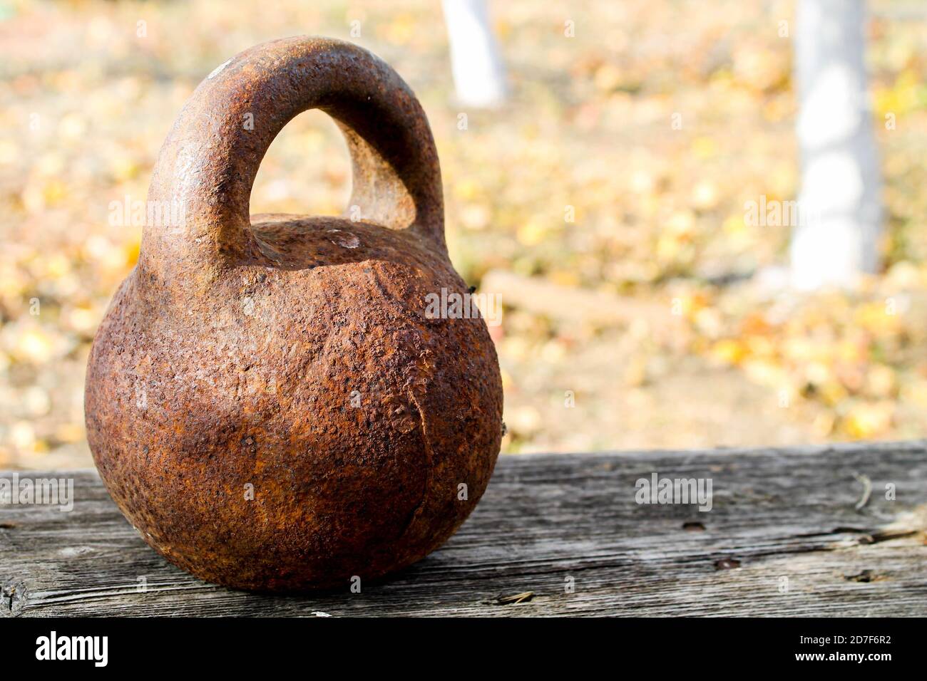 Rusty kettlebell on a wooden bench.An unused weight rusts outside Stock  Photo - Alamy