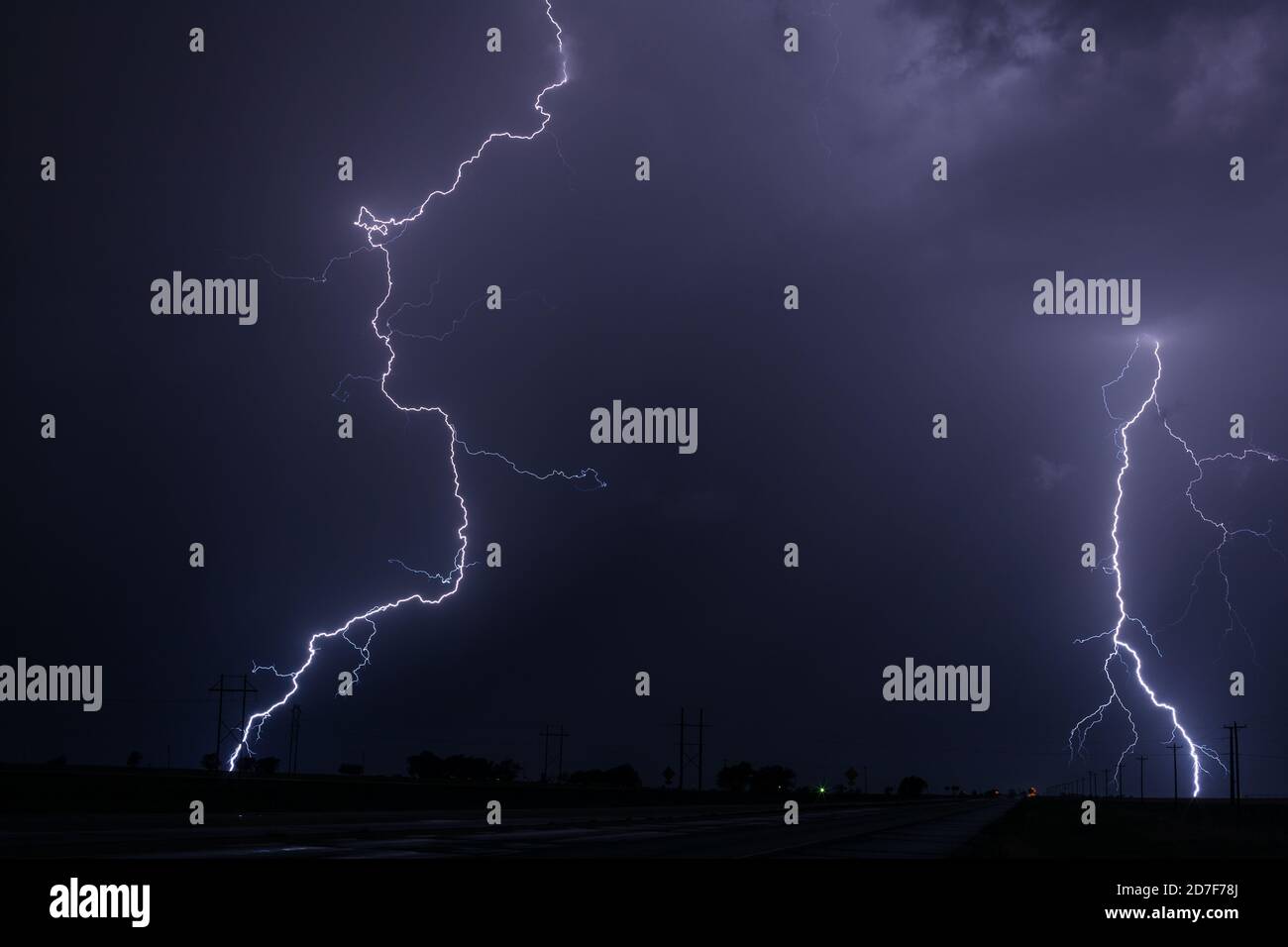 Cloud to ground lightning bolts strike during a summer thunderstorm near Kim, Colorado Stock Photo