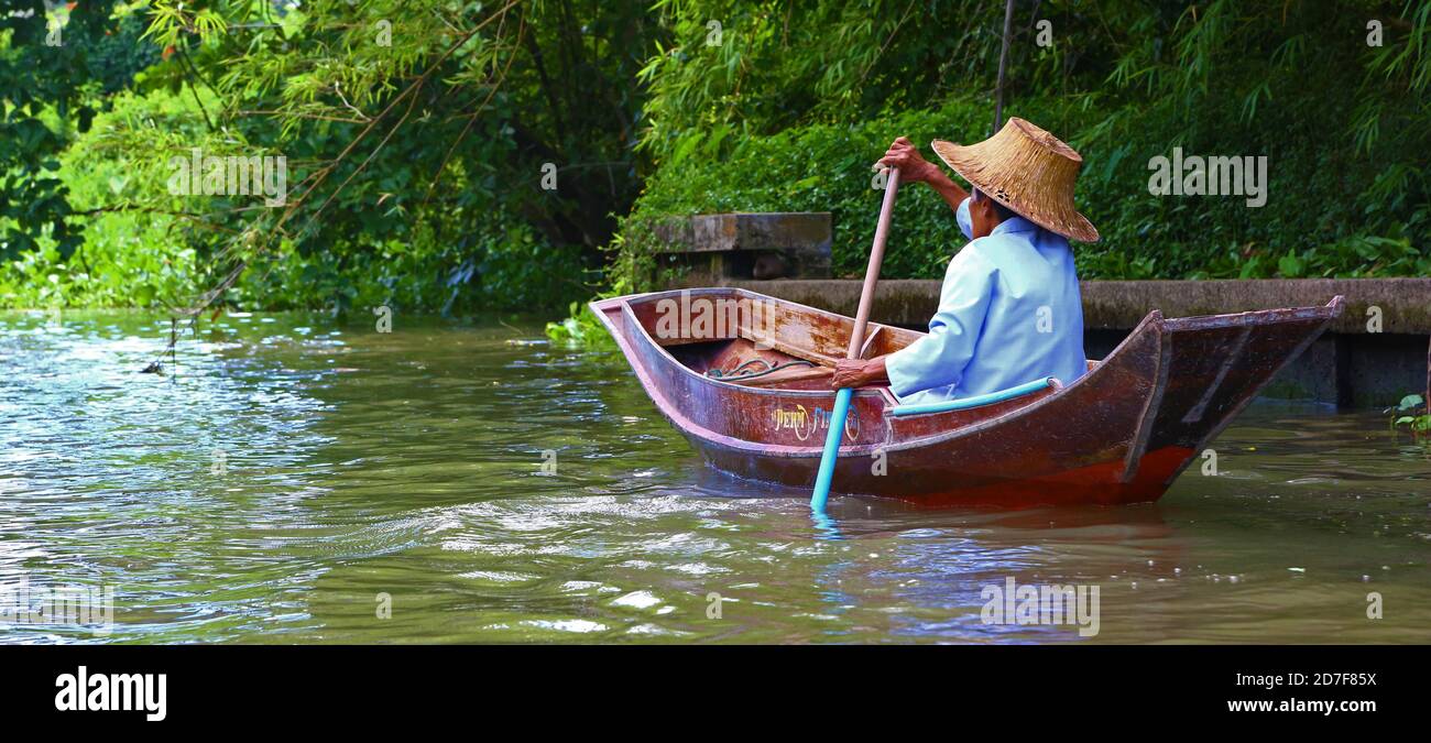 Woman paddling in Thailand Stock Photo