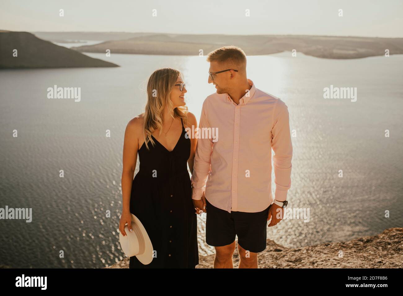 man and woman in love walk on a mountain above a large lake sea Stock ...