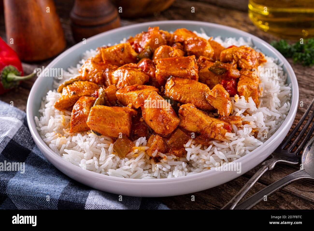 A plate of delicious creole cajun style chicken with white rice. Stock Photo