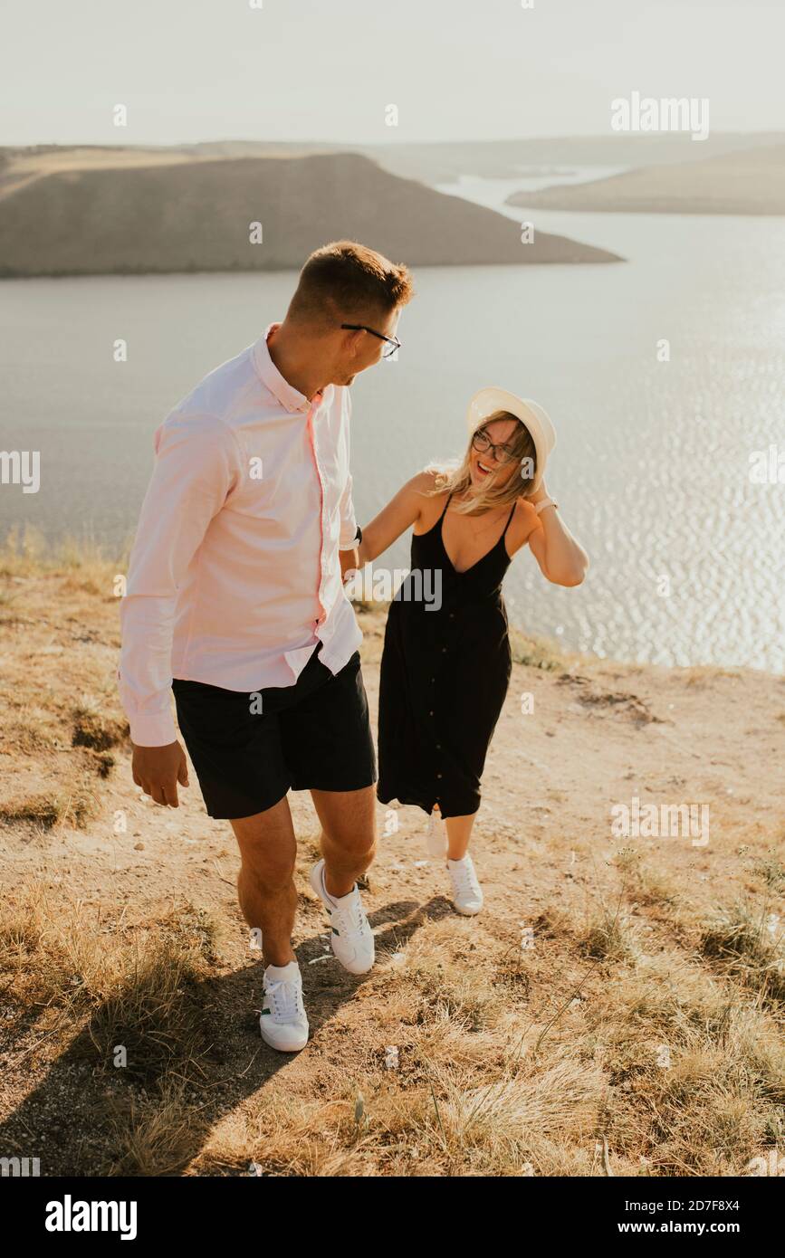 man and woman in love walk on a mountain above a large lake sea Stock ...