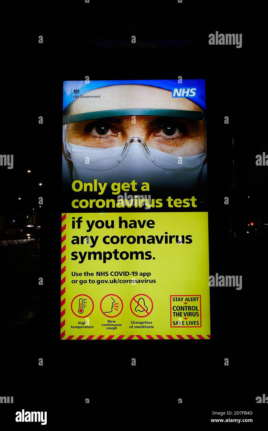 London, UK. - 22 Oct 2020: An electronic billboard at a bus stop in west London warns people to only get a coronavirus test if they have symptoms. Stock Photo