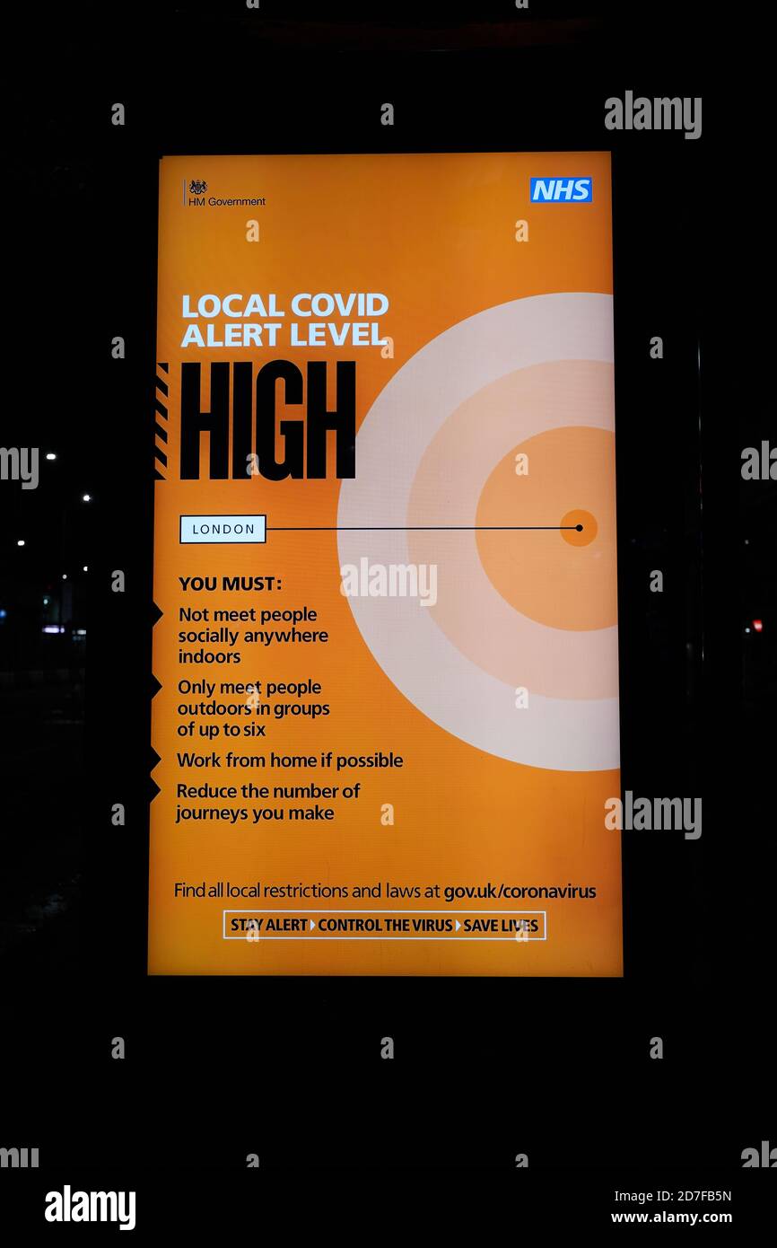 London, UK. - 22 Oct 2020: An electronic billboard at a bus stop in west London warns of a high local  coronavirus alert level. Stock Photo