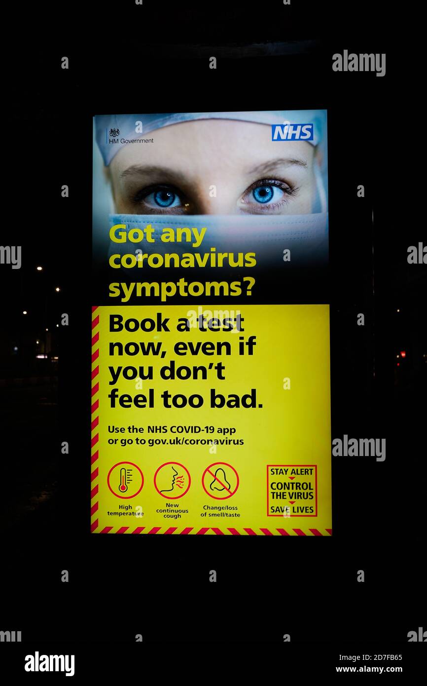 London, UK. - 22 Oct 2020: An electronic billboard at a bus stop in west London warns people to get a coronavirus test if they have symptoms. Stock Photo
