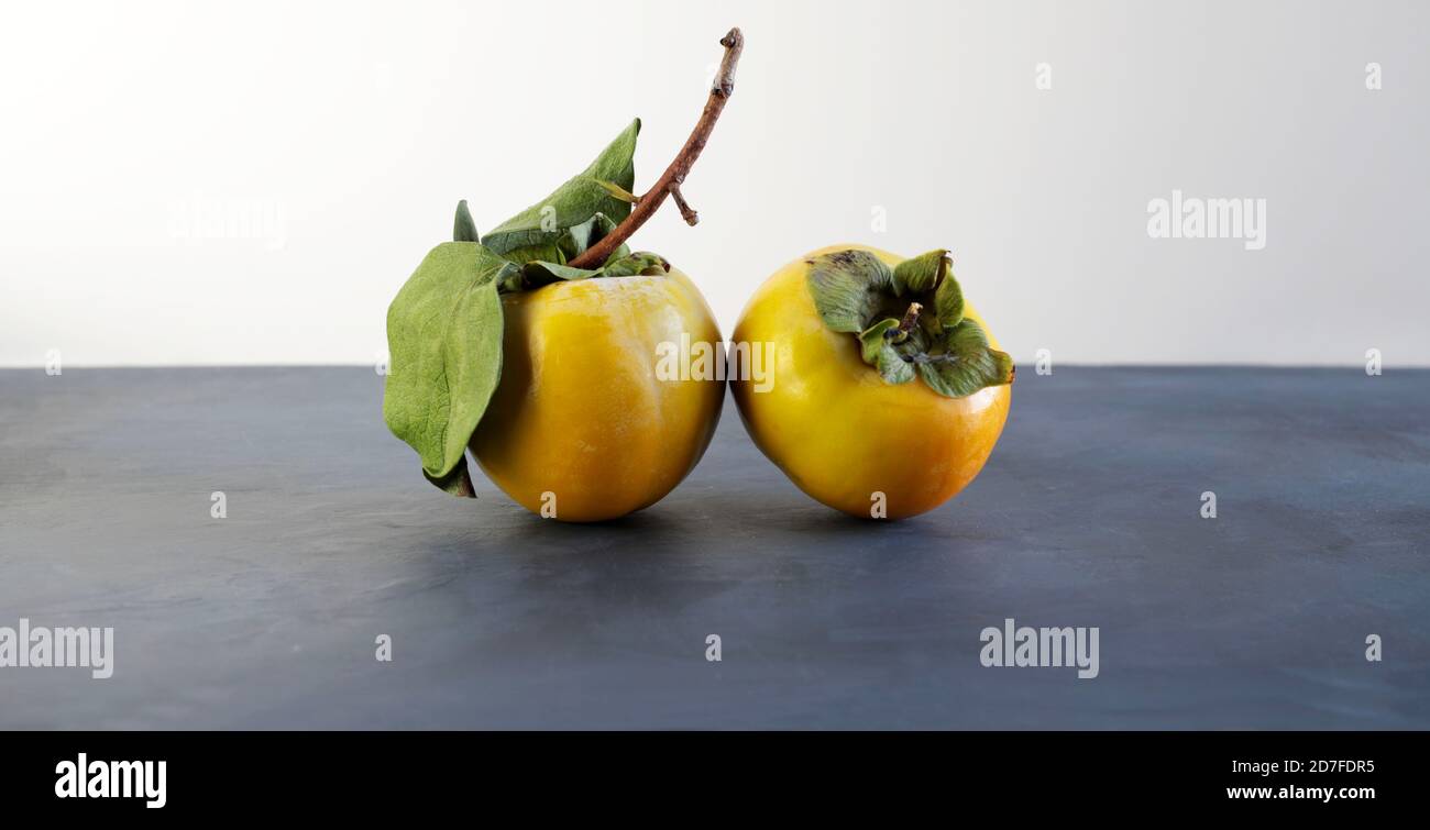 Fresh persimmons on white background Stock Photo