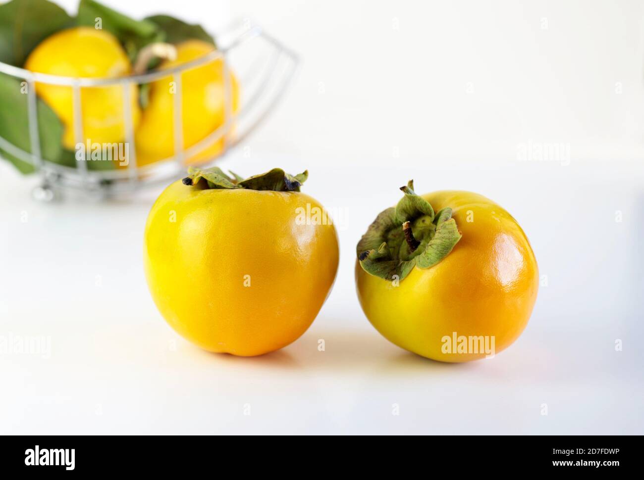 Fresh persimmons on white background Stock Photo