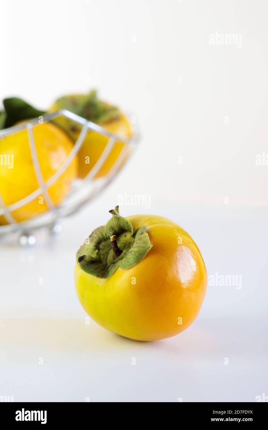 Fresh persimmons on white background Stock Photo