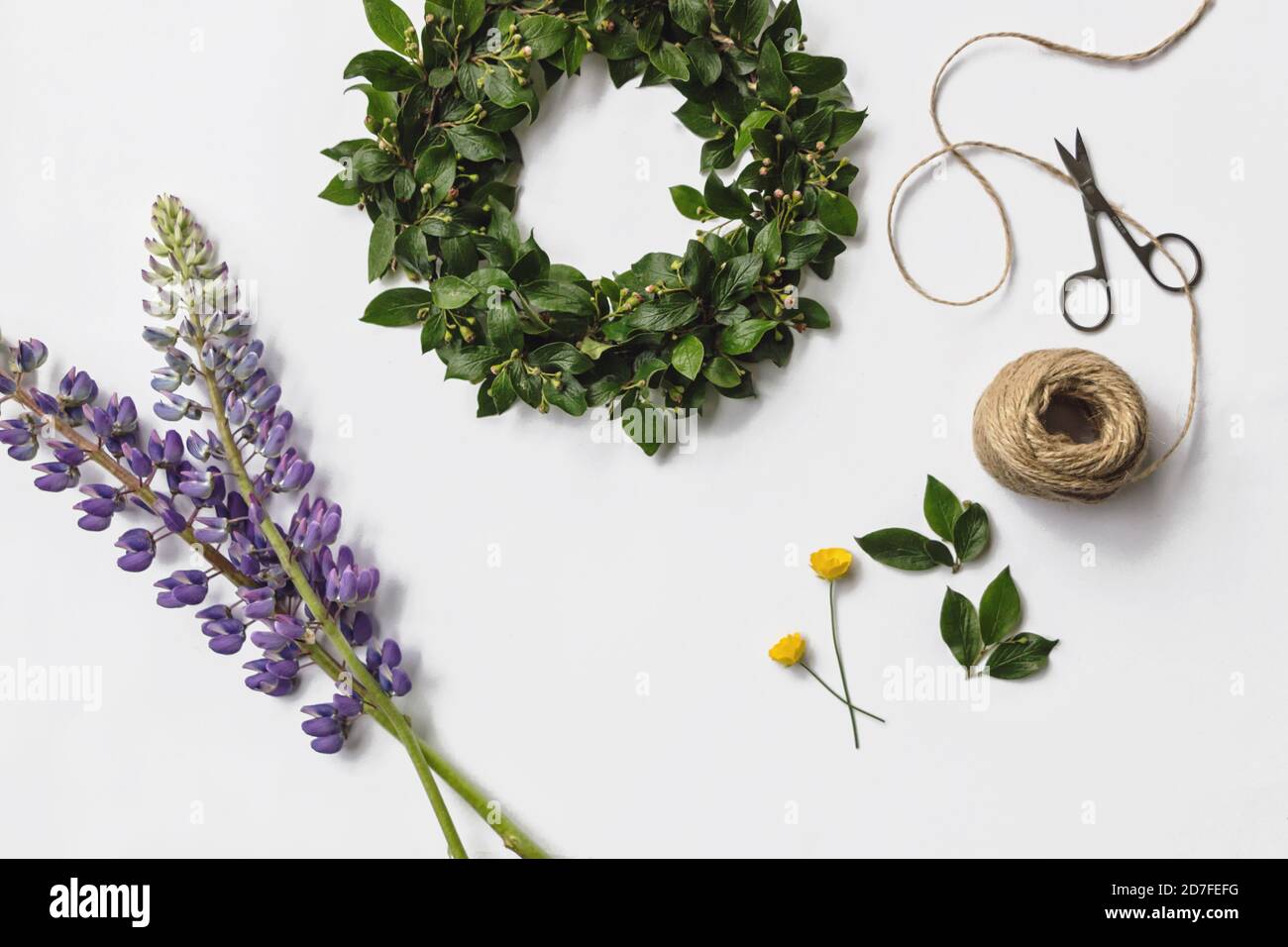 DIY midsummer flower wreath flat lay on white background Stock Photo