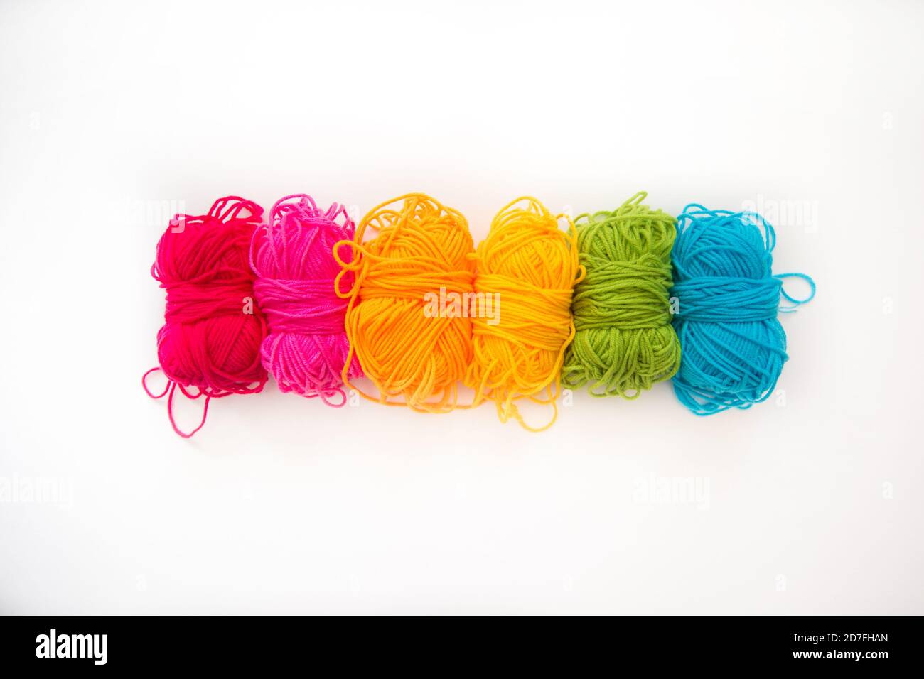 multicolored balls with yarn on a white background Stock Photo