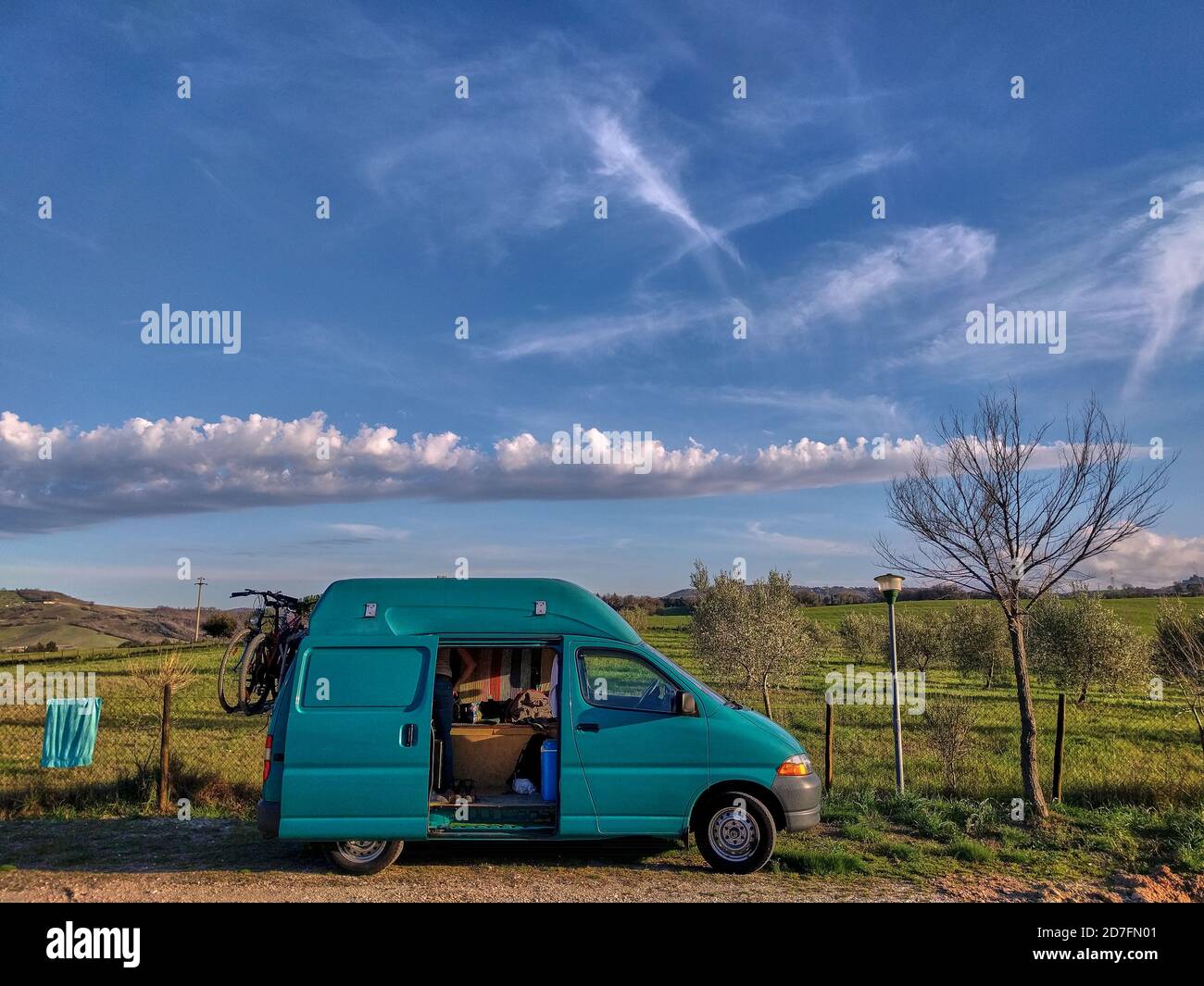 Campervan on a green field with blue sky. Green camper beneath blue sky.  Roadtrip with a campervan. Campervan on a green field in the summer Stock  Photo - Alamy