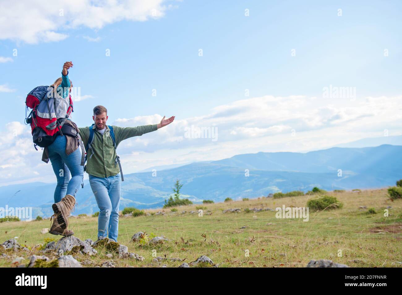 Two hikers with backpack standing on top of a mountain and look Stock ...