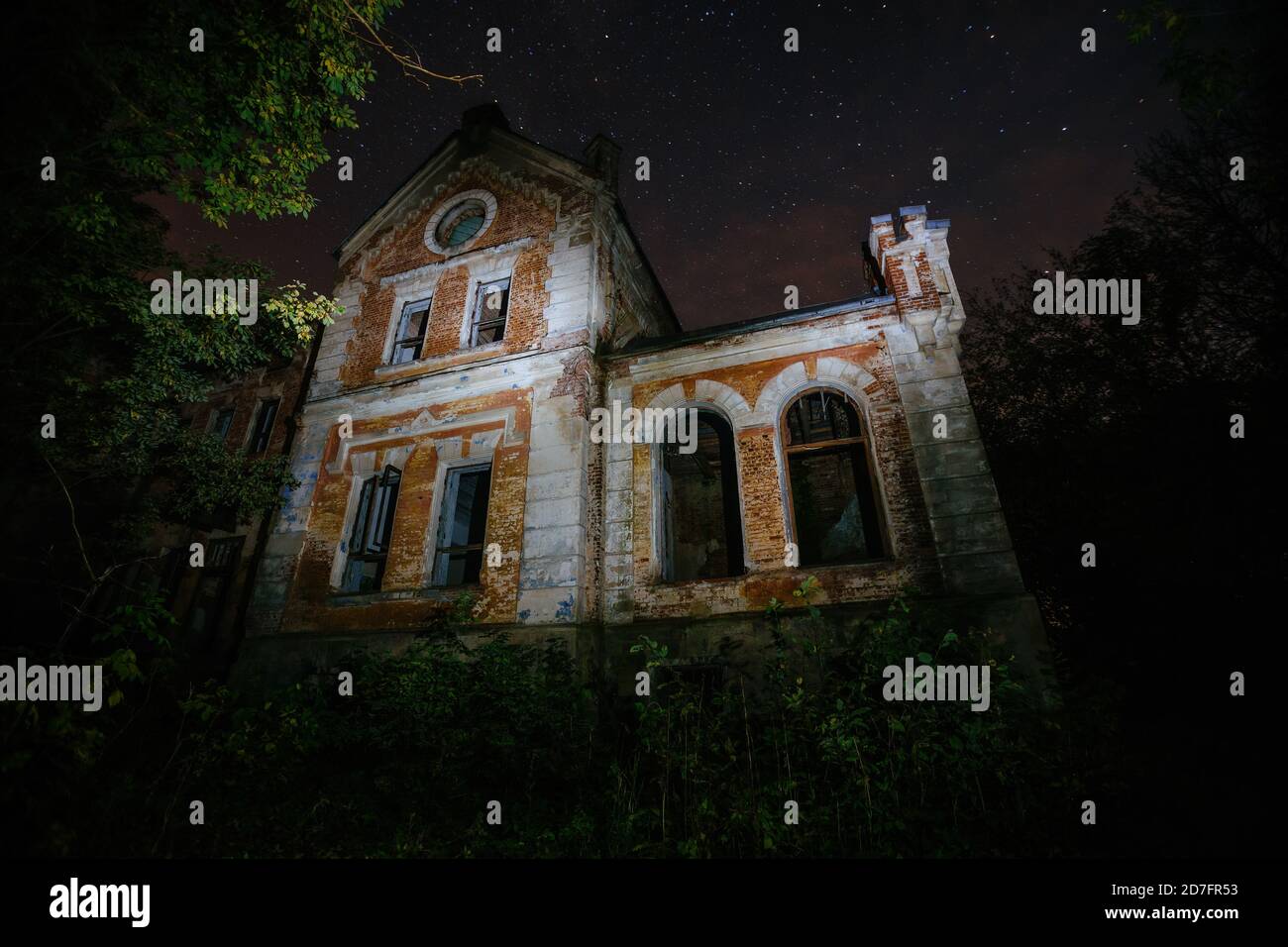 Dark and creepy old abandoned haunted mansion at night. Former Karl von