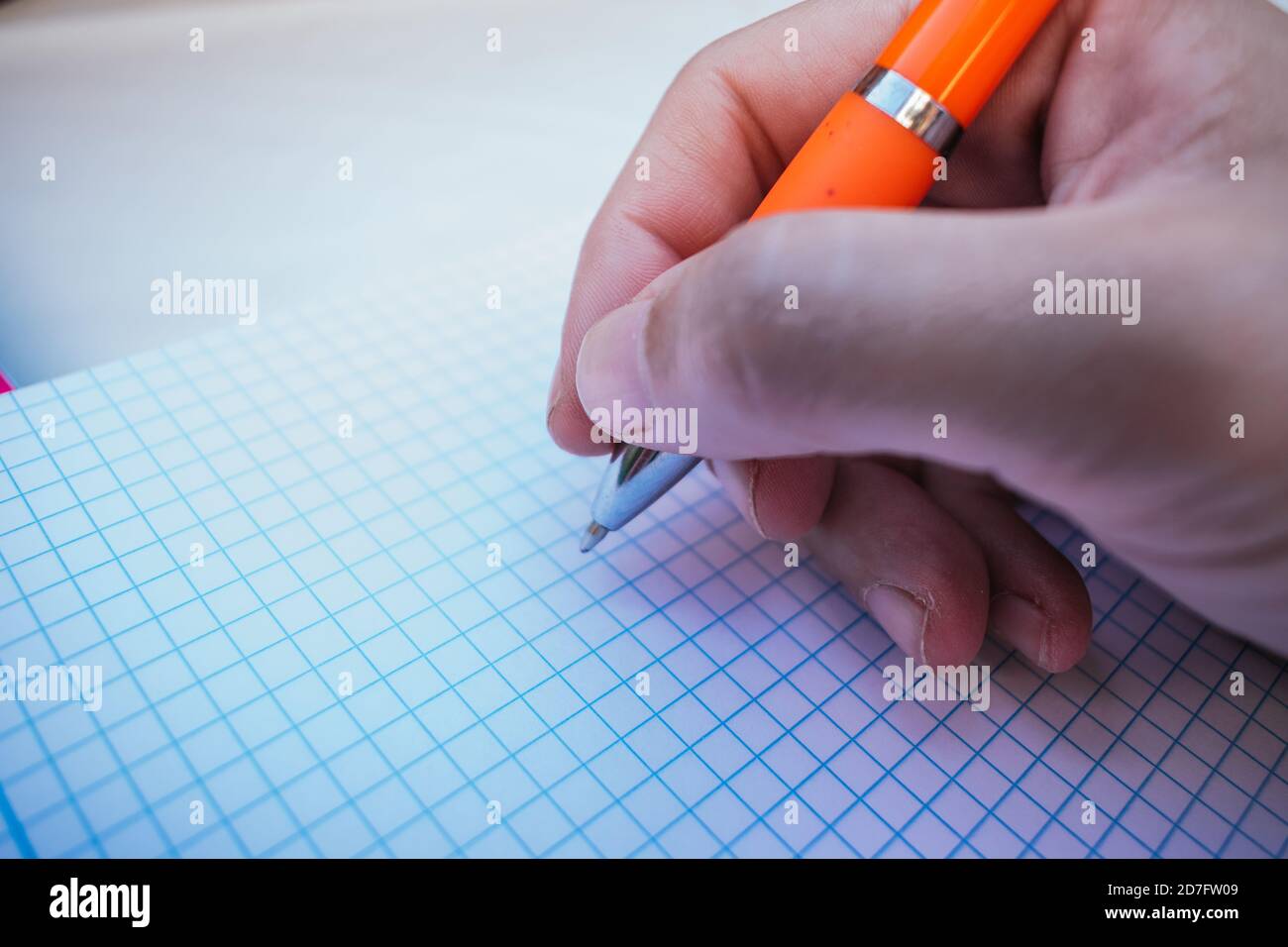 close-up of a hand writing in a notebook Stock Photo