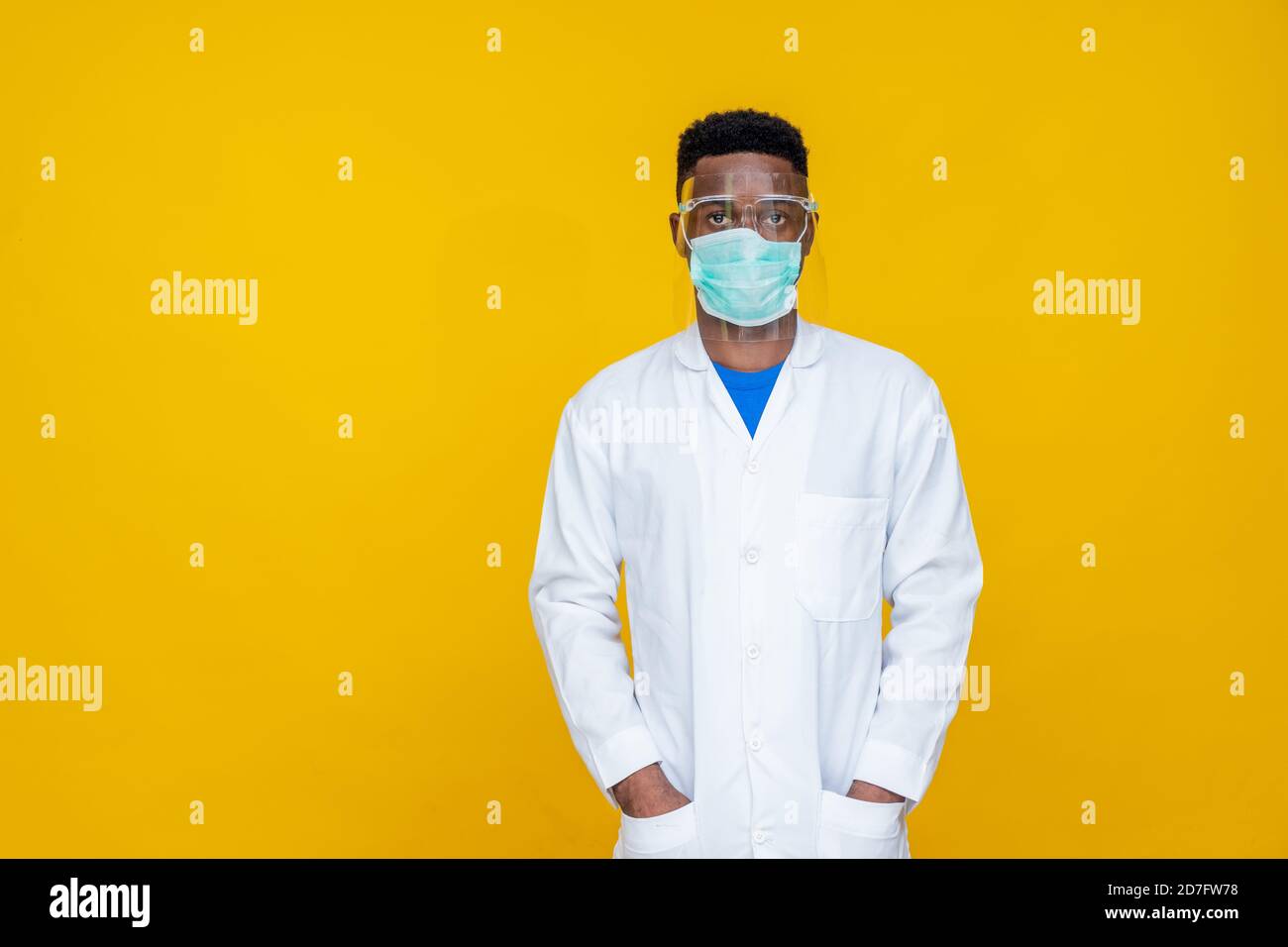 portrait of an african medical personnel wearing a lab coat, face mask
