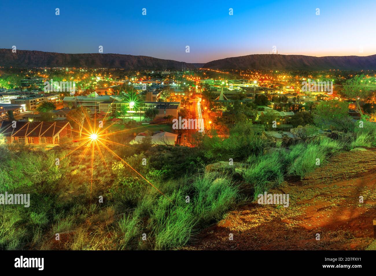 night view of Alice Springs skyline in Australia from Anzac Hill Memorial lookout with main buildings of Alice Springs city downtown. Red Centre Stock Photo