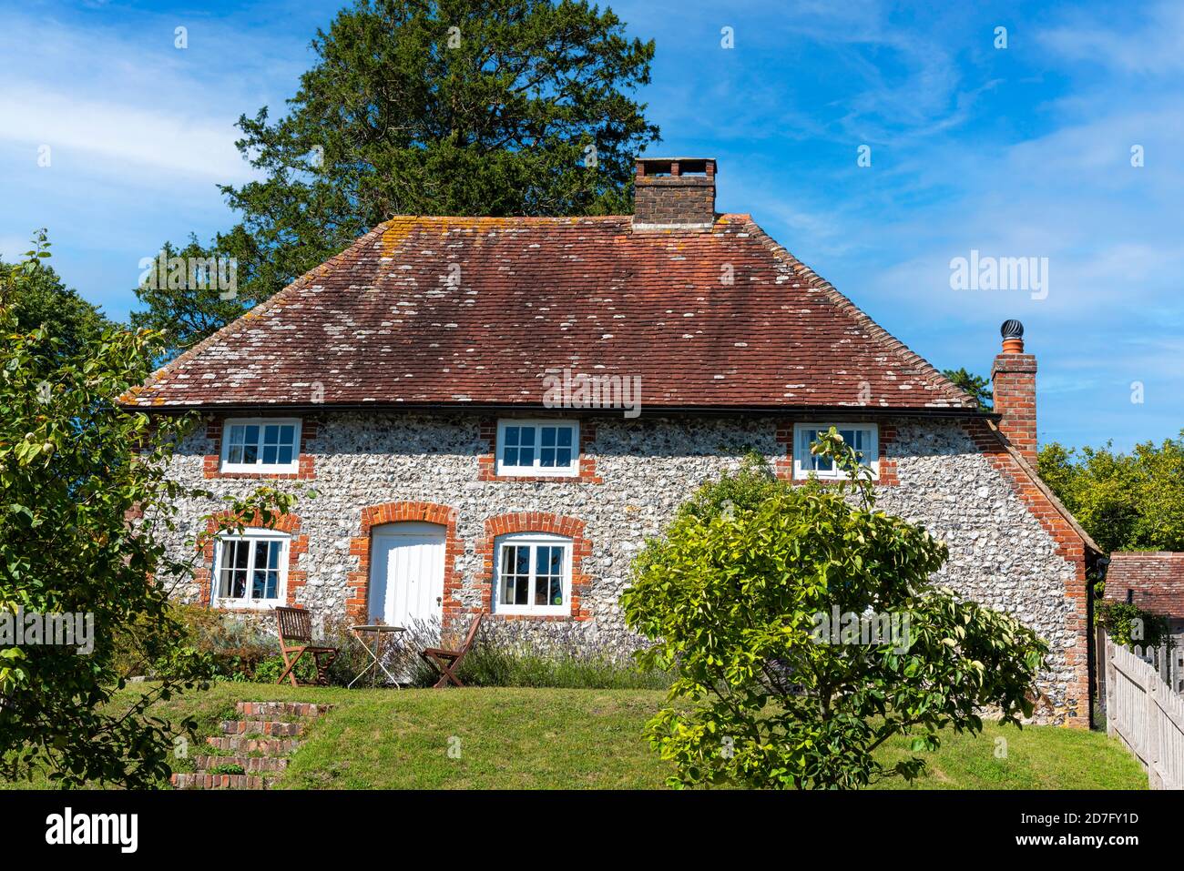 A traditional Sussex flint cottage in the village of East Dean at the foot of the South Downs in West Sussex. Stock Photo