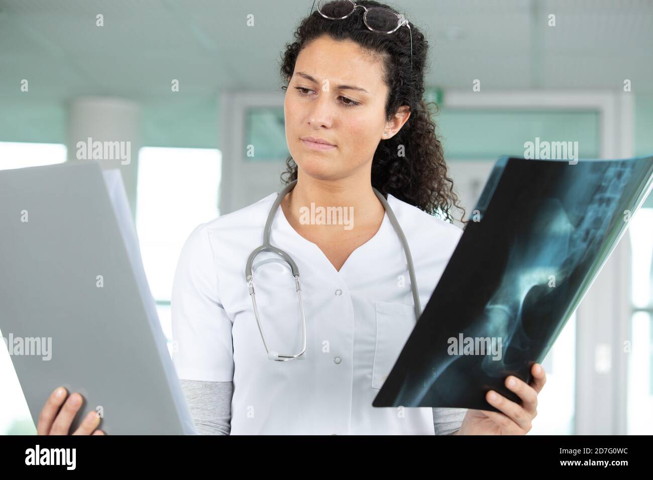nurse is comparing x-ray results Stock Photo