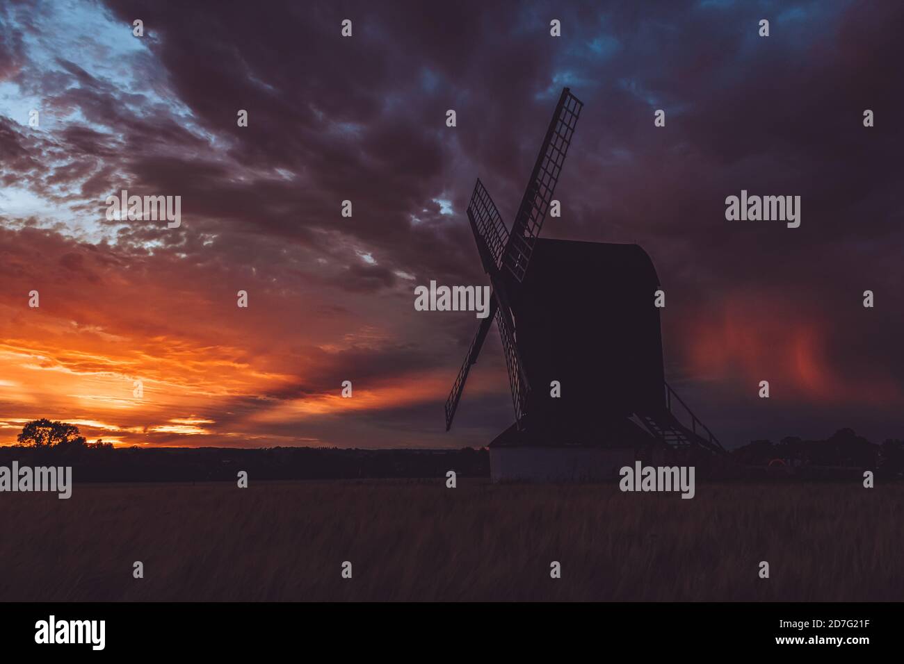 Pitstone, United Kingdom - 31 July 2020: Stunning sunset landscape view for Pitstone Windmill with dramatic cloudy sky and beautiful colors of sun Stock Photo